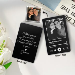 May include: Black metal card with a photo and text. The front side has a photo and music player design with the text "Your favorite song". The back side has a romantic message and the name "Jasmine".