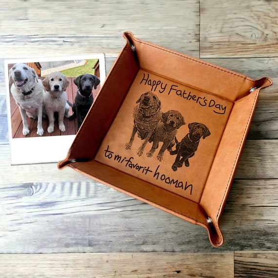 A full-grain leather valet tray laser-engraved with your actual dog's photo — every dog dad empties his pockets onto a portrait of his best friend.
