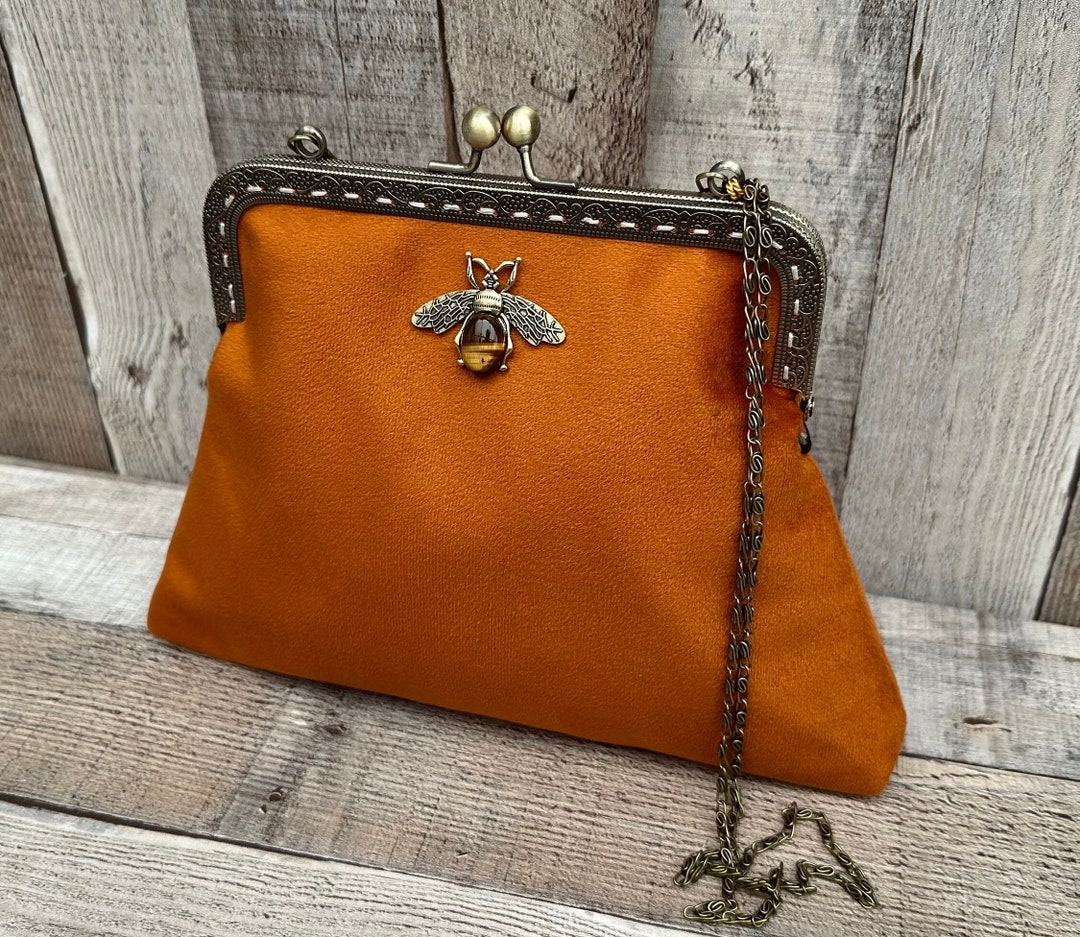 Orange leather clutch bag deals