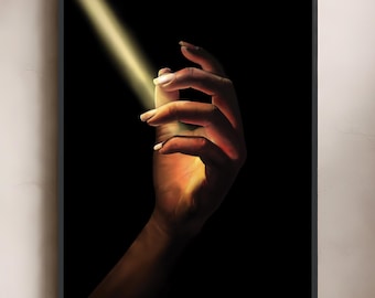 May include: A framed vertical wall art print featuring a hand reaching into a diagonal beam of warm golden light against a solid black background. The light illuminates the fingers and palm, creating a glowing effect with deep shadows.