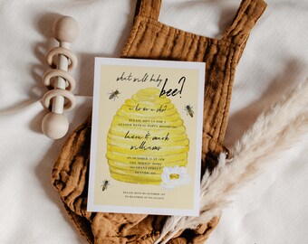 May include: A yellow and white gender reveal party invitation with a beehive illustration and the text "what will baby bee? a he or a she?"  Please join us for a gender reveal party honoring Laura & Mark Williams on October 1st at 1 PM. The Morris Home, 243 Grant Street, Hunter, CO. Please RSVP by October 1st to Heather at 907.342.0124.