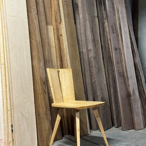 Sculptural solid wood slab chair, composed of three slabs of solid wood, 4 legs, and a satin brass connector