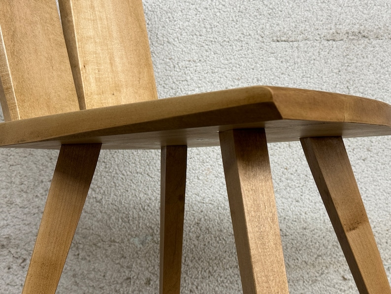 Sculptural solid wood slab chair, composed of three slabs of solid wood, 4 legs, and a satin brass connector