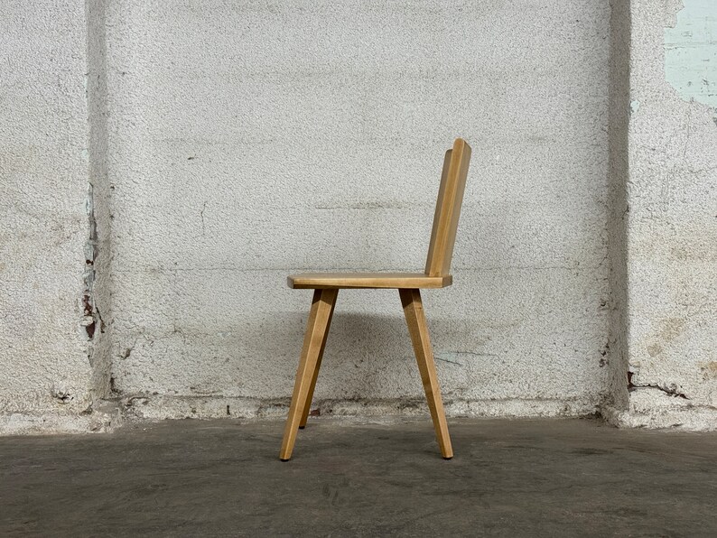 Sculptural solid wood slab chair, composed of three slabs of solid wood, 4 legs, and a satin brass connector