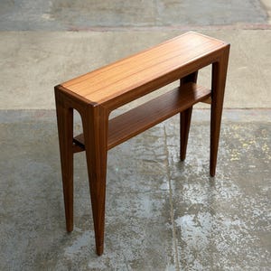 May include: A set of three ceramic mugs with a speckled, matte finish. The mugs are in shades of cream, light gray, and dark gray. Each mug has a simple, minimalist design, perfect for coffee or tea.