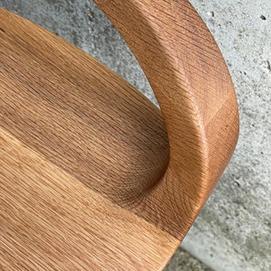detail photo of modern swivel counter stool with tractor seat showing the flowing hand-sculpted curves, made of solid oak, made in the USA by Marco Bogazzi
