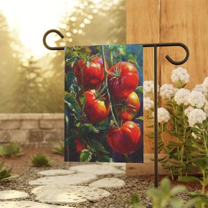 May include: A garden flag featuring a vibrant painting of ripe red tomatoes on the vine. The tomatoes are depicted with realistic detail, surrounded by green leaves. The flag is displayed on a black metal garden stake, perfect for outdoor decor.