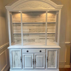 Vintage hutch with removable glass shelving, two piece hutch,  painted white with lights, wood-like panel backboard,  dining room display