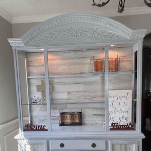 Vintage hutch with removable glass shelving, two piece hutch,  painted white with lights, wood-like panel backboard,  dining room display