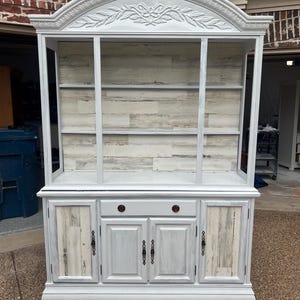 Vintage hutch with removable glass shelving, two piece hutch,  painted white with lights, wood-like panel backboard,  dining room display