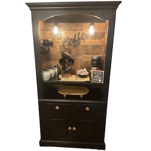 Black and panel board backing coffee bar, wood knobs, black caged lights, coffee and wine bar
