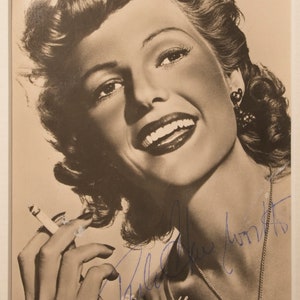 Rita Hayworth signed photograph display. Genuine Rita Hayworth autographed photo