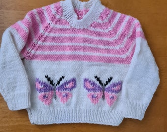 New, hand knitted child's jumper featuring butterfies,