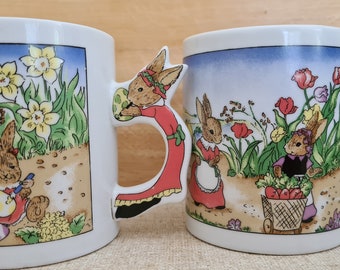 Vintage EASTER mugs, near new never used. handle shaped like a rabbit, 2 different scenes in a field