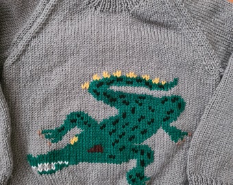 NEW - Hand knitted childs jumper featuring a crocodile