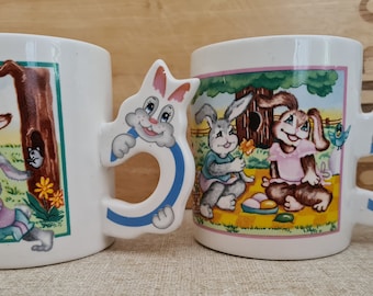 Vintage Easter mugs, featuring 2 rabbits, bunnies having fun in the countryside.