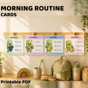 Könnte beinhalten: Ein Set aus vier farbenfrohen Morgenroutine-Karten mit Illustrationen eines grünen Monsters. Die Karten tragen die Aufschriften "Get Dressed", "Eat Breakfast", "Brush Teeth" und "Pack Bag". Die Wörter "MORNING ROUTINE CARDS" und "Printable PDF" sind ebenfalls sichtbar.
