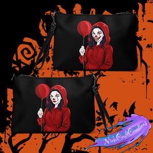May include: Black clutch bags featuring a red-hooded clown holding a red balloon. The clown has white face paint and a sinister smile. Each bag has a black wrist strap. The background is black and orange.