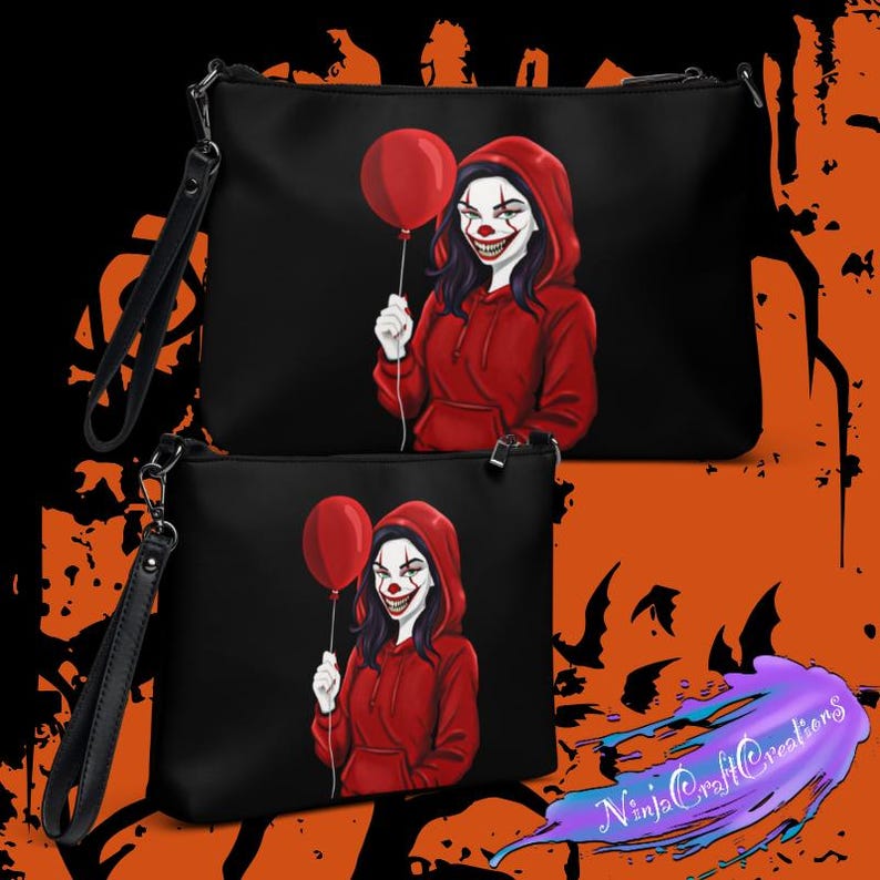 May include: Black clutch bags with a wrist strap, featuring a graphic of a clown holding a red balloon. The clown wears a red hoodie and has white face paint with a sinister smile. The bags are a Halloween theme.