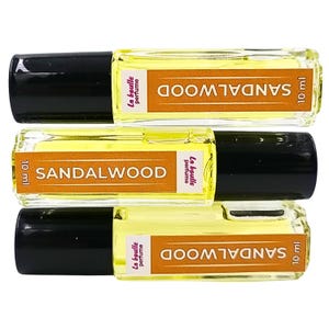 Pode incluir: Tr&ecirc;s frascos de perfume de s&acirc;ndalo de 10 ml com aplicador de bola. Os frascos s&atilde;o de vidro transparente com tampas pretas e etiquetas amarelas que dizem "SANDALWOOD" e "La boulle perfume".