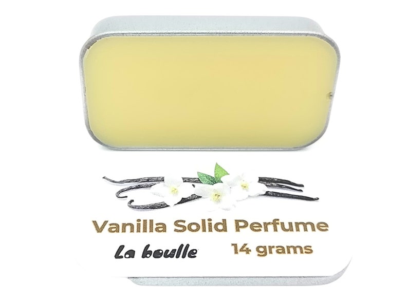 May include: A small silver tin with a yellow solid perfume inside. The tin is labeled "Vanilla Solid Perfume La Bouille 14 grams".