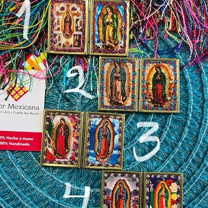 May include: Four different folding picture frames with images of the Virgin Mary. Each frame is decorated with glitter and has a gold trim. The frames are numbered 1 through 4.