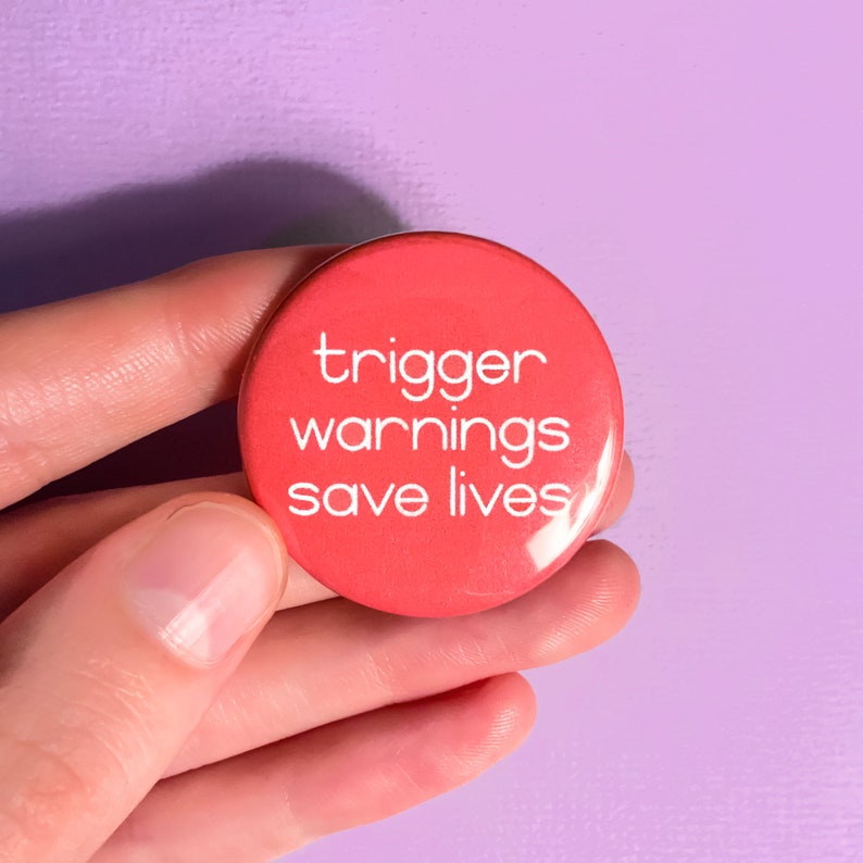 May include: A red button with the text "trigger warnings save lives" in white.