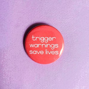 May include: A red button with the text "trigger warnings save lives" in white.