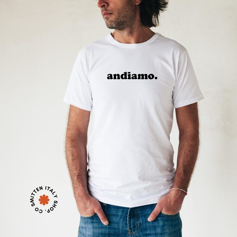 May include: White t-shirt with the text "andiamo." printed in black on the front.