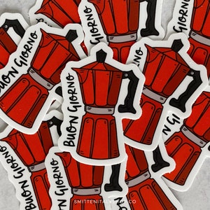 May include: A stack of stickers featuring a red and black illustration of a traditional Italian coffee maker, with the text "Buon Giorno" on each sticker.
