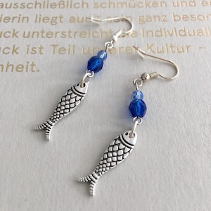 Brincos, pingente de peixe e ganchos de orelha banhados a prata, pedras de vidro lapidadas em azul, comprimento aprox. 6 cm