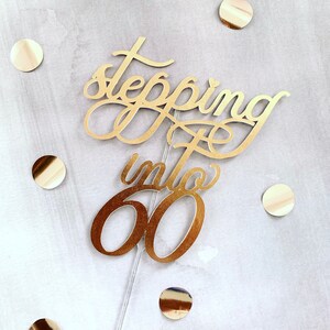 Rose Gold &quot;Stepping Into 60&quot; Cake Topper: Metallic Cursive