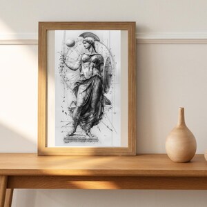 May include: A black and white pencil drawing of a woman in a flowing robe holding a sword and shield. The drawing is framed in a wooden frame and is set against a white wall.