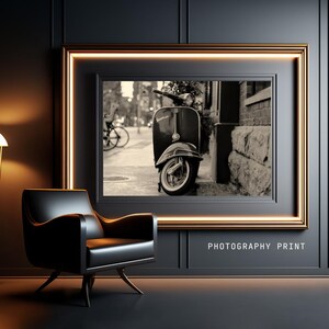 May include: A black and white photograph of a vintage scooter parked on a city street. The scooter is in focus, while the background is blurred. The image is framed in a gold frame and labeled "PHOTOGRAPHY PRINT".