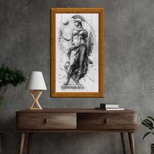 May include: A black and white drawing of a woman in a flowing gown, holding a spear and a shield. The drawing is framed in a wooden frame and is set against a gray background.