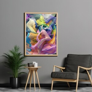 May include: Abstract art print with swirling colors of yellow, blue, purple, and green. The print is framed in a light wood frame and is hanging on a gray wall.
