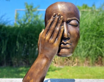 Bronze sculpture of a face with hand - Abstract and contemporary bronze garden sculpture