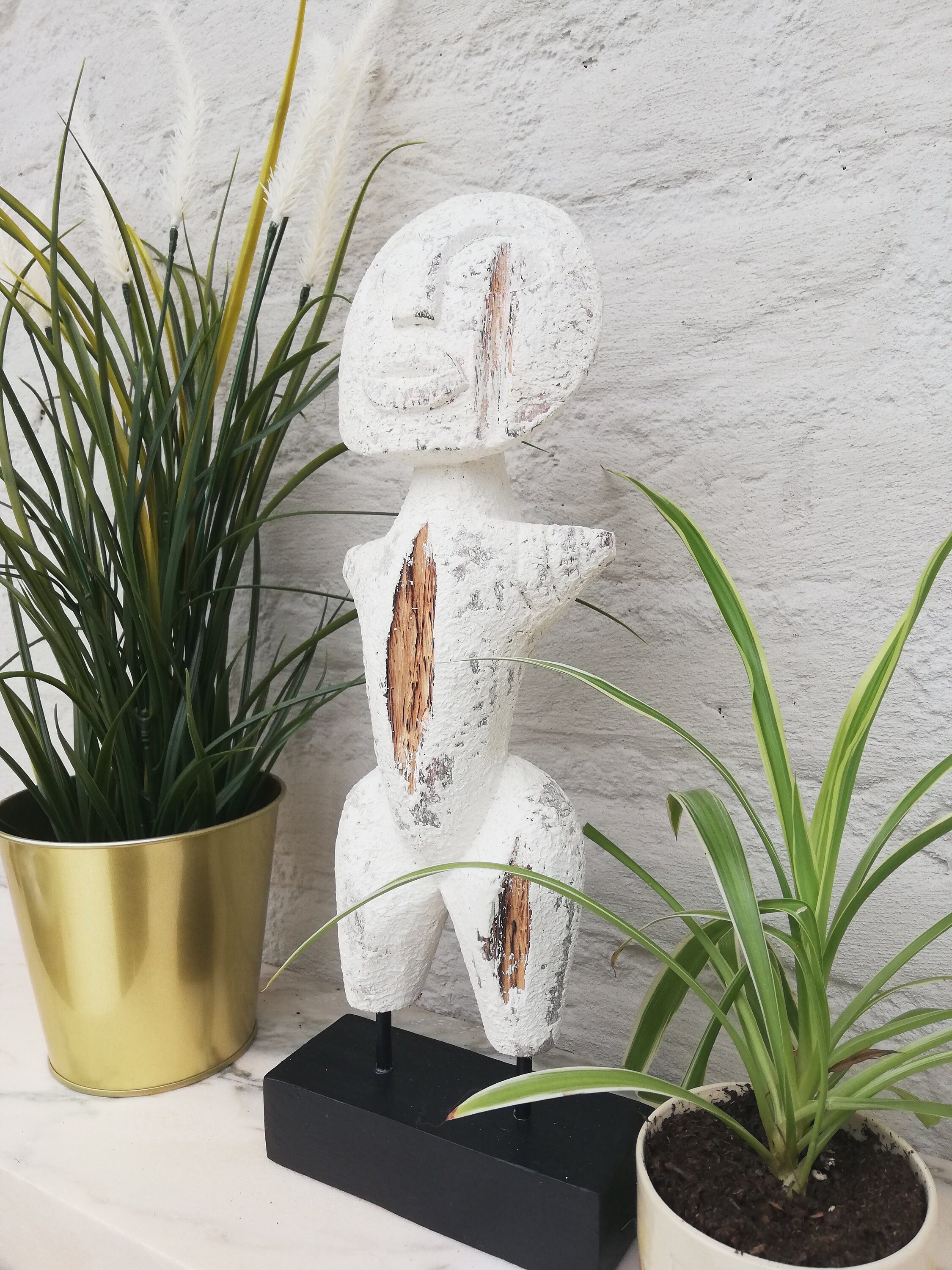 Wooden primitive statue on stand