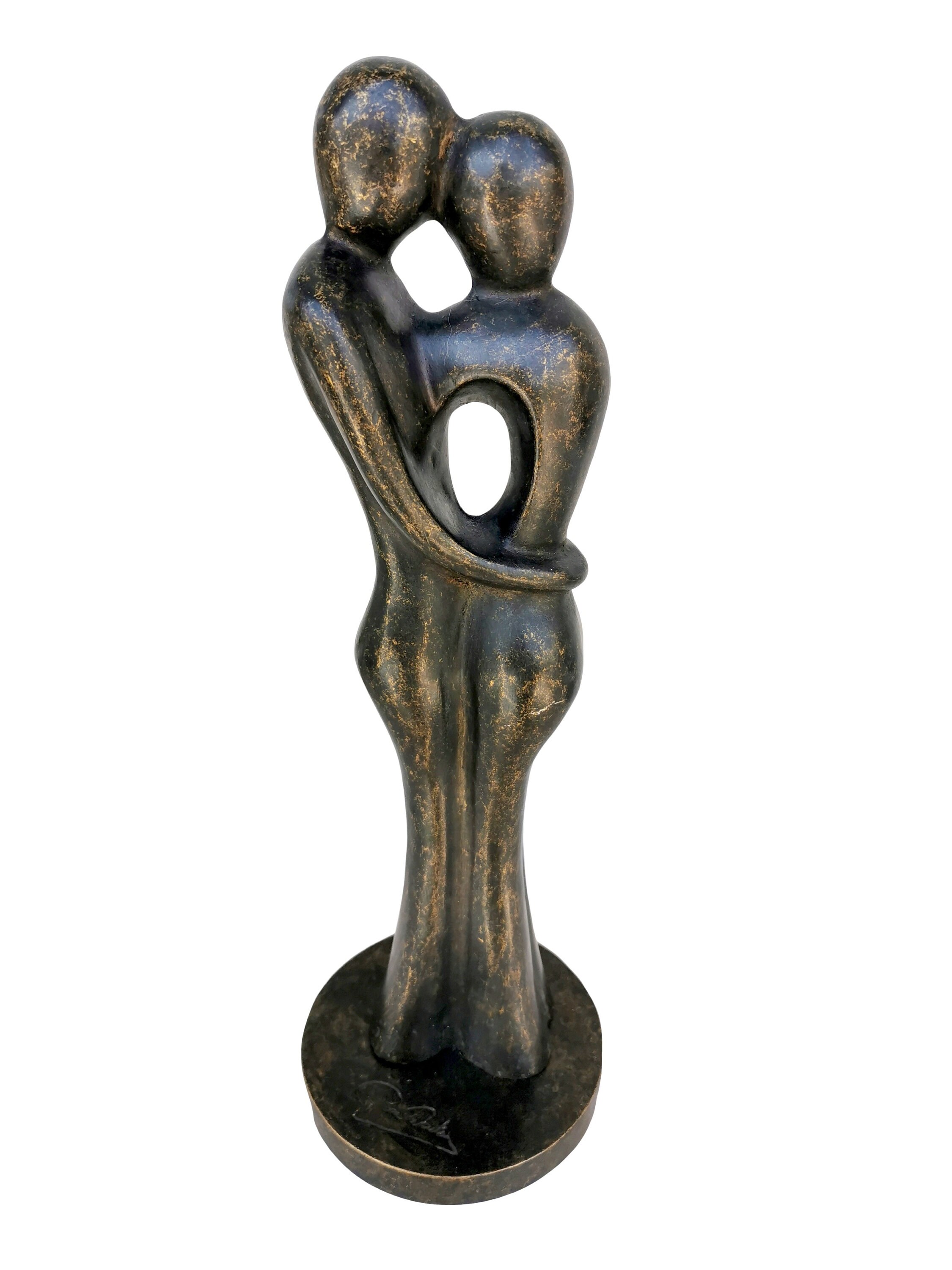 A bronze sculpture of a loving couple