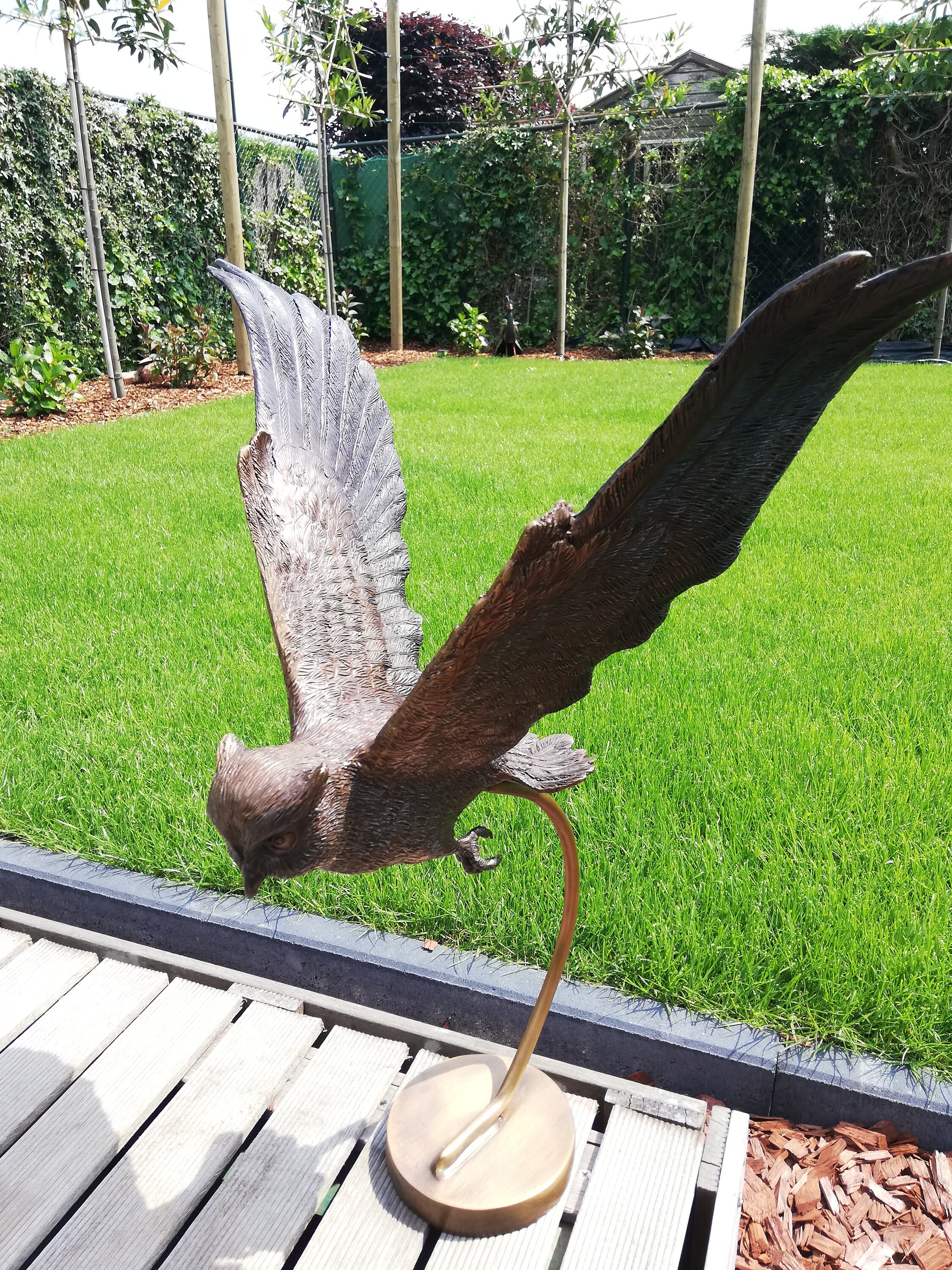 Large flying owl made out of bronze Garden sculpture