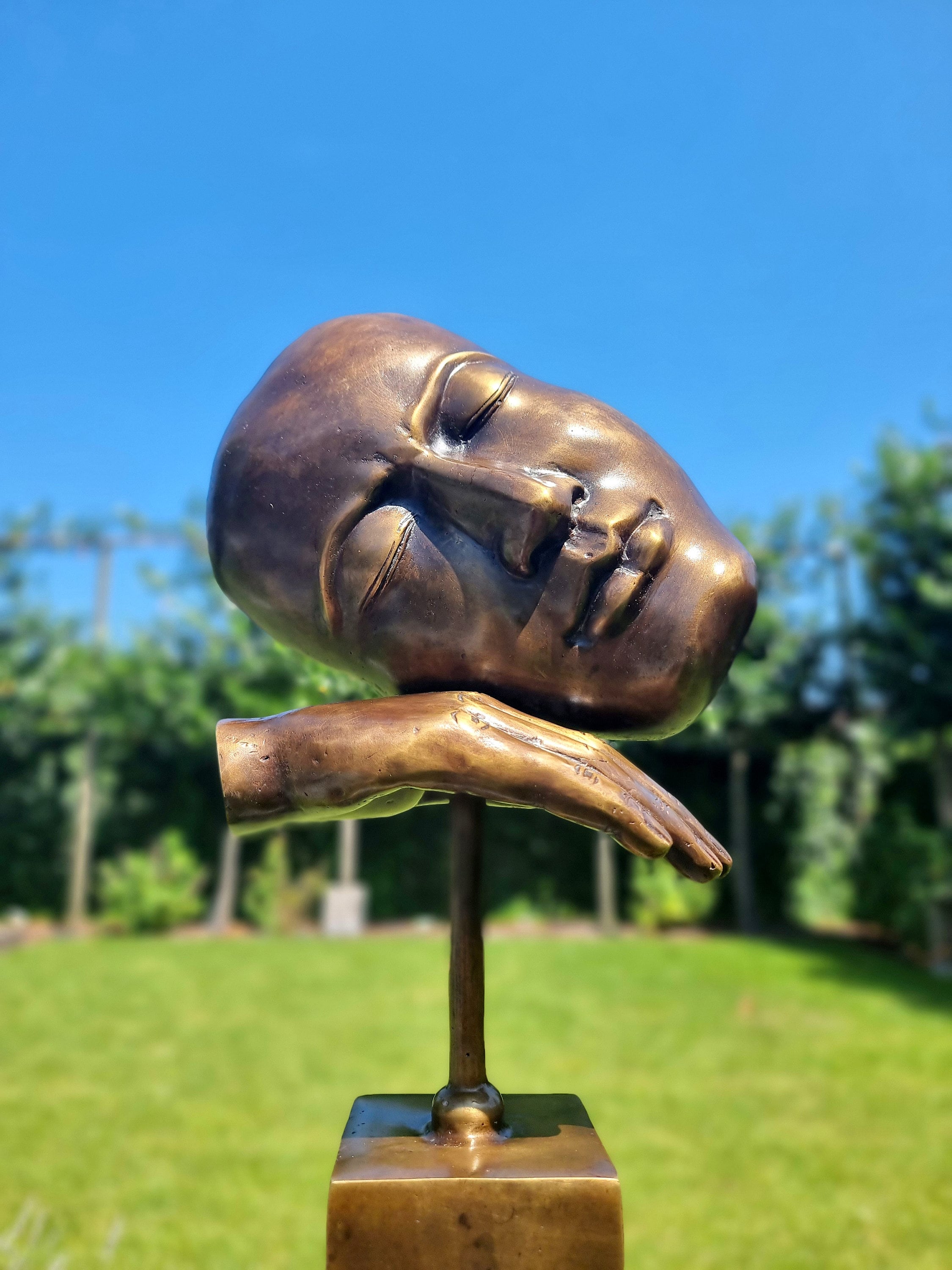 Bronze sculpture of a face with hand Abstract and contemporary bronze