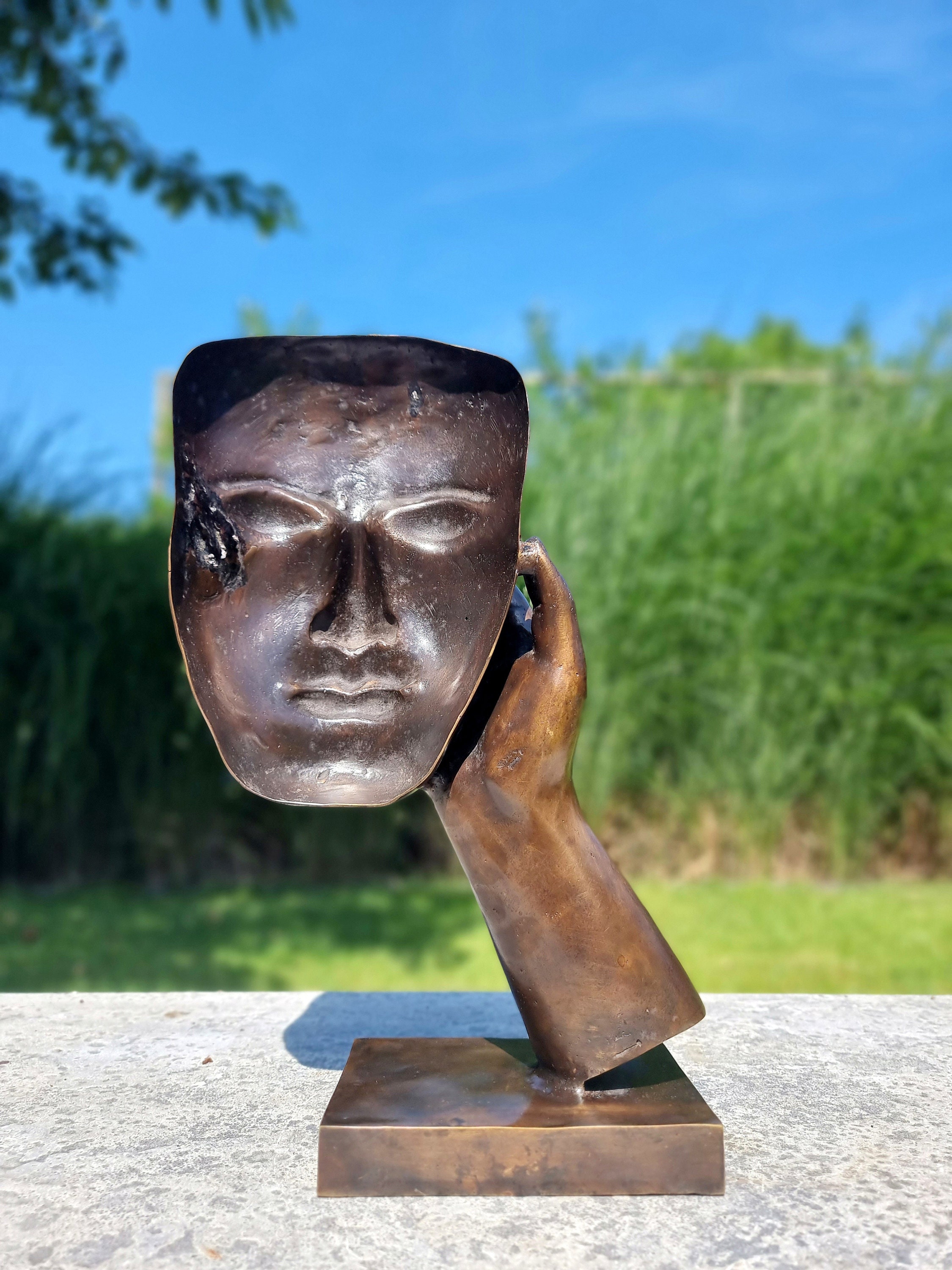 Bronze sculpture of a face with hand Abstract and contemporary bronze