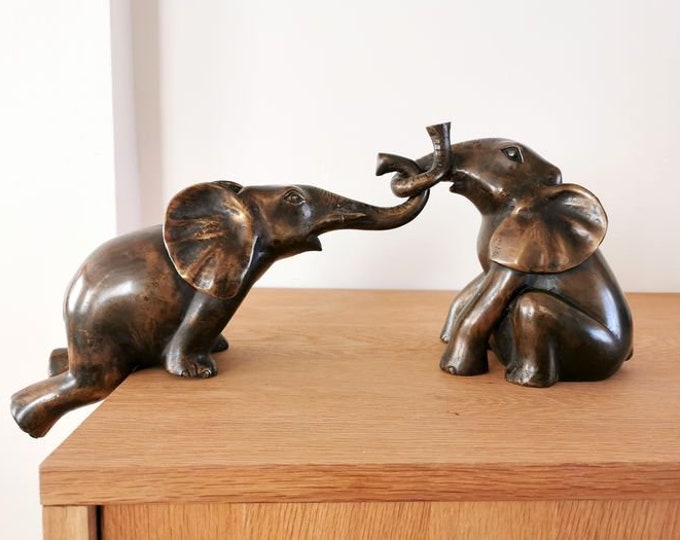 Bronze baby elephants - helps falling elephant