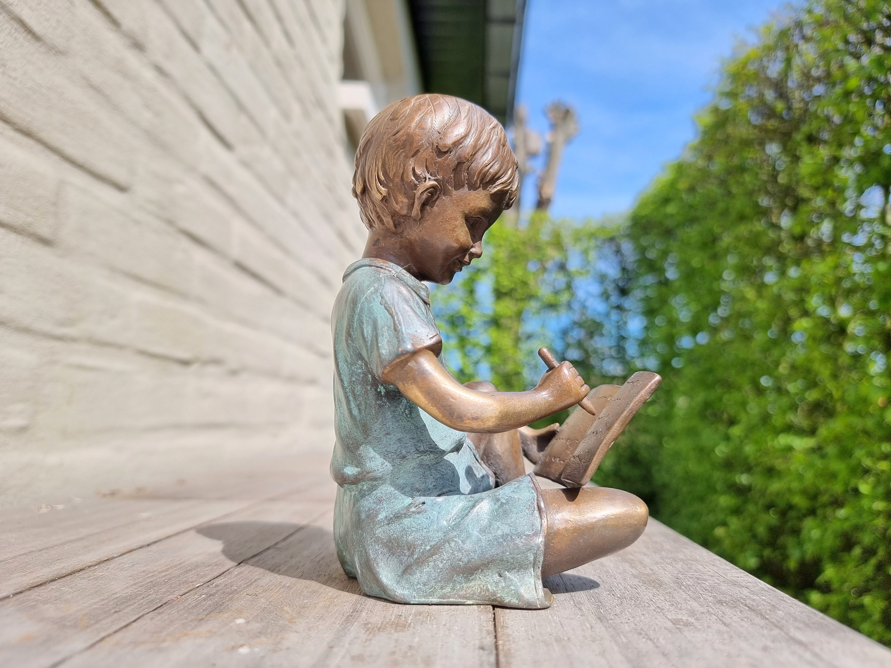 Bronze sculpture of a boy reading a book - Bronze garden ornaments