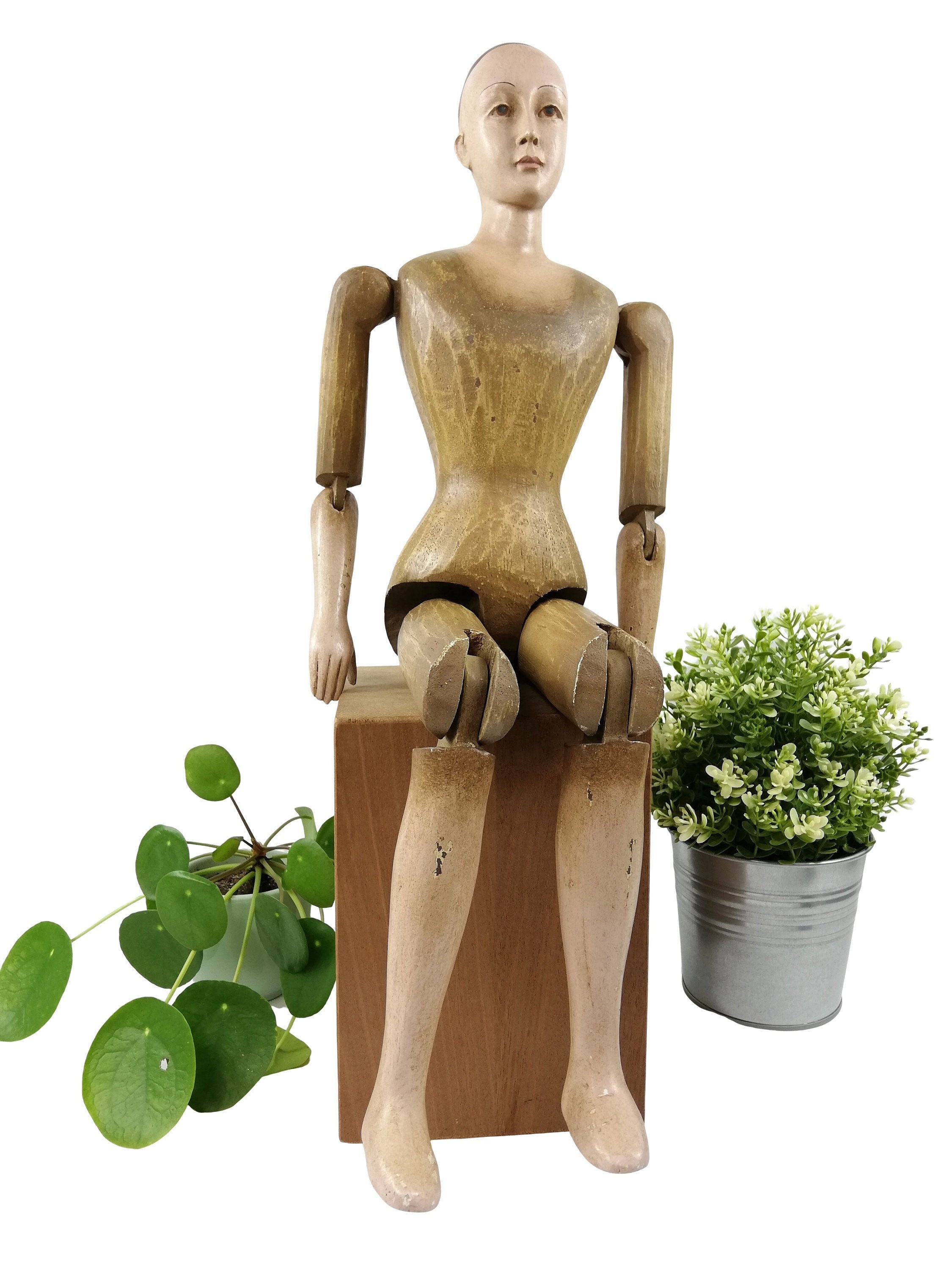 A large wooden mannequin