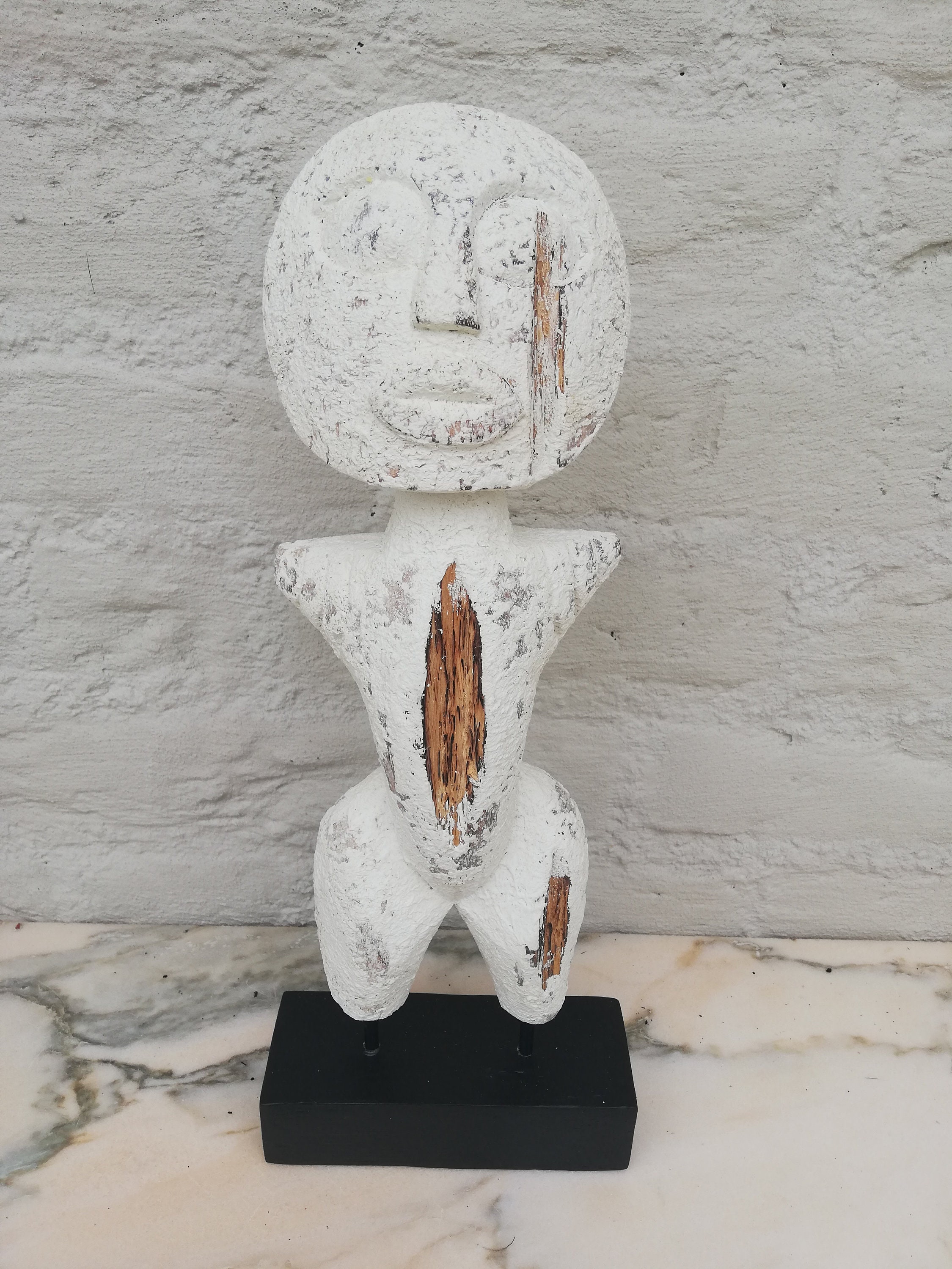 Wooden primitive statue on stand