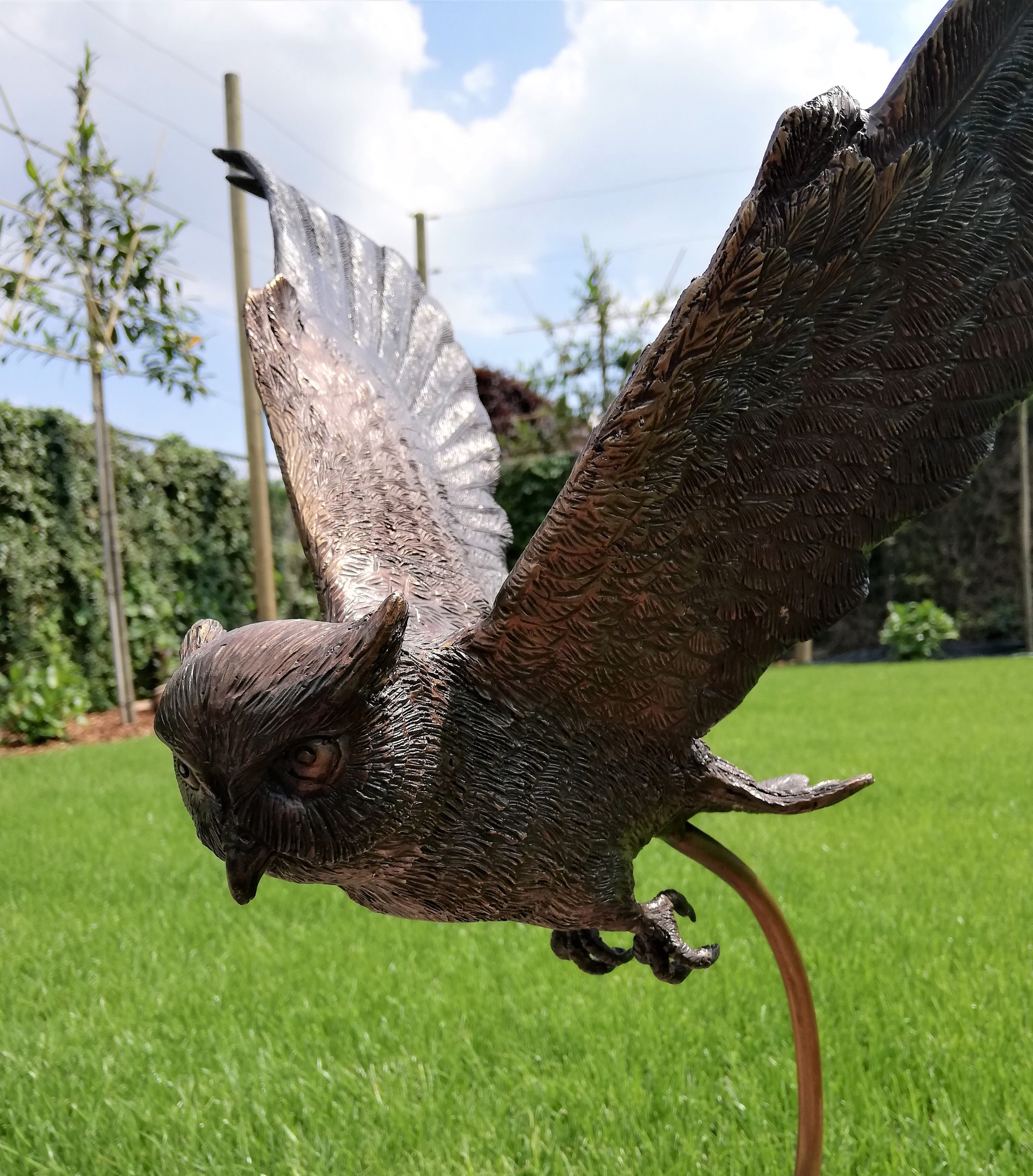 Large flying owl made out of bronze Garden sculpture