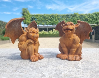 A pair of cast iron gargoyles - Small decorative sculptures - finials - fantasy garden ornaments