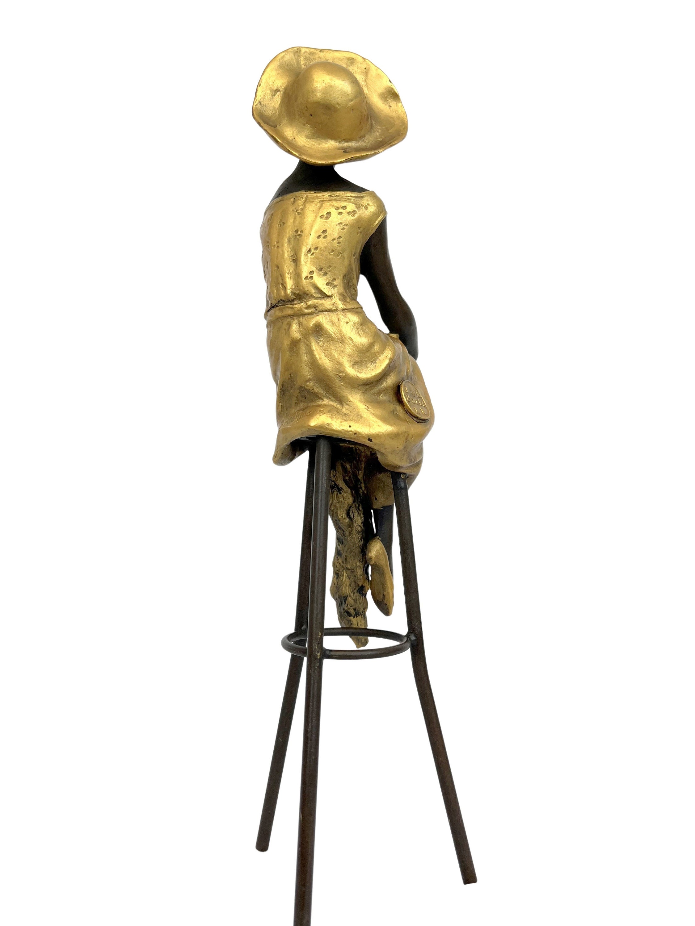 Bronze sculpture of a woman on a bar stool Graceful and elegant
