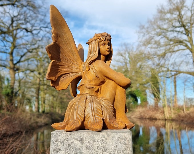 Cast iron seated fairy of moving beauty: A comforting presence full of deep emotion - Enchanting and comforting garden decoration